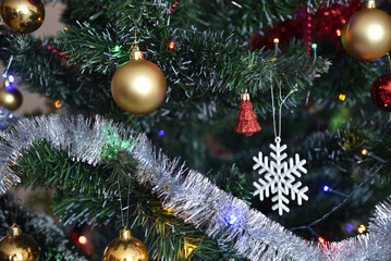 Christmas season with colorful, decorated christmas tree, chains and balls.