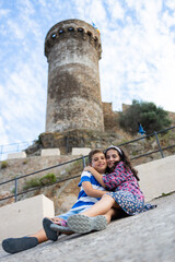 Portrait of two kids with a castle tower in the background