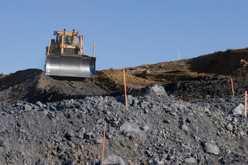 A bulldozer grading a new road.; Petaluma, California.