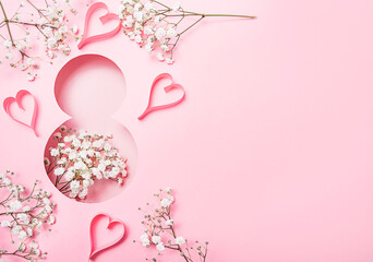 Fototapeta na wymiar International Women's Day. Postcard for March 8. Flowers and hearts in the shape of the number eight on a pink background. Banner. Copy space.