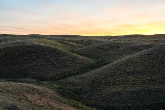 Sunset over the hills of Grasslands National Park, Saskatchewan; Val Marie, Saskatchewan, Canada
