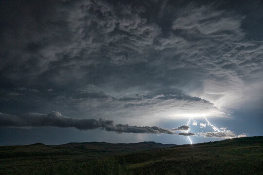 Lightning strikes from a passing supercell thunderstorm in Saskatchewan; Val Marie, Saskatchewan, Canada