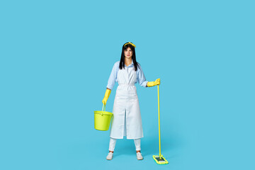 woman in rubber gloves and cleaner apron with cleaning supplies