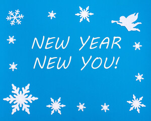 Naklejka na ściany i meble New Year's motivational card. Text NEW YEAR NEW YOU on a blue background with Christmas snowflakes, a white angel