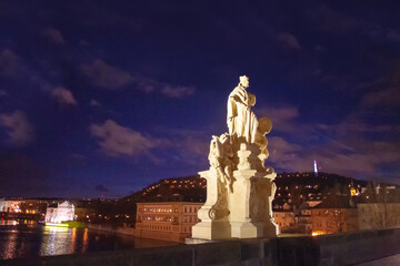 Fototapeta na wymiar Old medieval Statue on Charles bridge in Prague - illuminated