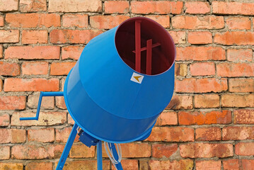 concrete mixer on the background brick wall