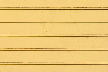 Horizontal boards in light yellow paint wooden surface texture plank background