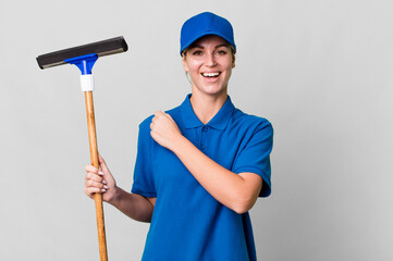 caucasian blonde woman feeling happy and facing a challenge or celebrating. windows washer concept