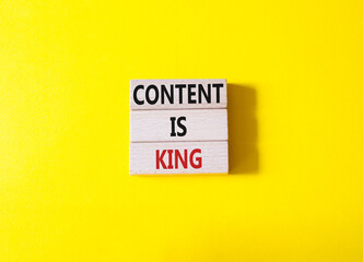 Content is king symbol. Concept words Content is king on wooden blocks. Beautiful yellow background. Business and Content is king concept. Copy space.