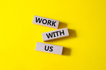 Work with us symbol. Wooden blocks with words Work with us. Beautiful yellow background. Business and Work with us concept. Copy space.