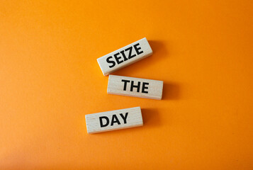 Seize the day symbol. Wooden blocks with words Seize the day. Beautiful orange background. Business and Seize the day concept. Copy space.
