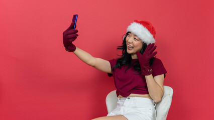 Photo of charming lady holding telephone making selfies speaking skype waving palm saying hi...