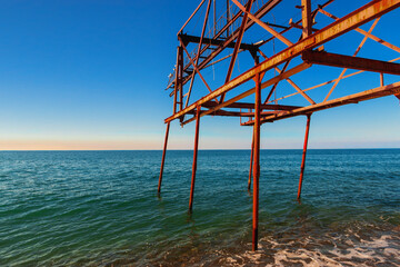 Turquoise water and surf on the Black Sea coast. Photo of the sea and the coast. Crashing waves on...