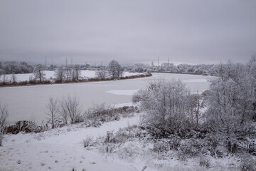 winter landscape of river Lielupe near Jelgava town in Latvia. Snow and ice covered stream