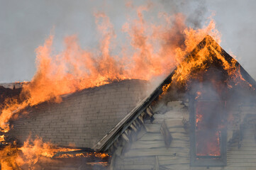 Local firefighters use a controlled burning of a house for practice.; Palmyra, Nebraska, United States of America