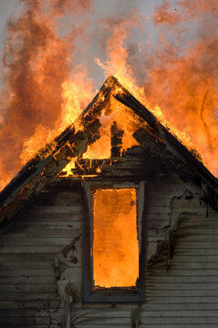 Local firefighters use a controlled burning of a house for practice.; Palmyra, Nebraska, United States of America