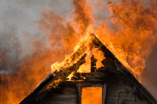 Local firefighters use a controlled burning of a house for practice.; Palmyra, Nebraska, United States of America