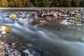 Water flowing over rocks. A long exposure on the river flowing through the rocks. Long exposure time. A long exposition of the river in the Caucasus mountains.