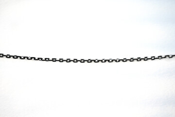 Black metal chain on a background of snow.