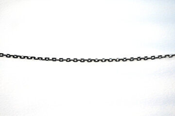 Black metal chain on a background of snow.