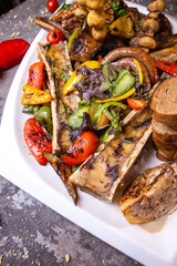 A set of various beef meat dishes on a white plate