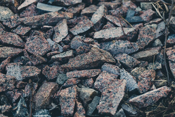 Gray small rocks ground texture. black small road stone background. gravel pebbles stone seamless texture. dark background of crushed granite gravel, close up. clumping clay