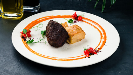 Fried beef fillet steak with sauce and microgreens.