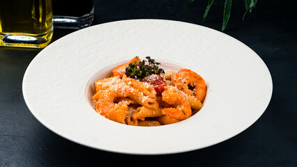 Lunch Penne pasta with shrimp, tomatoes, parmesan cheese and sauce.