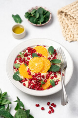 Couscous salad with oranges, pomegranate seeds and mint. Seasonal fruit salad. Middle eastern food