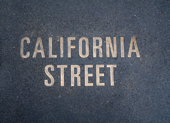 Brass-embedded street sign for California Street in San Francisco. High-quality photo of a sidewalk-embedded sign