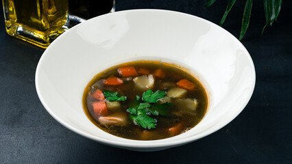 Mushroom soup with potatoes, carrots, onion and parsley.
