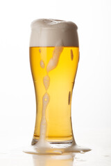 Glass of light beer isolated on white background, foam, bubbles, close-up