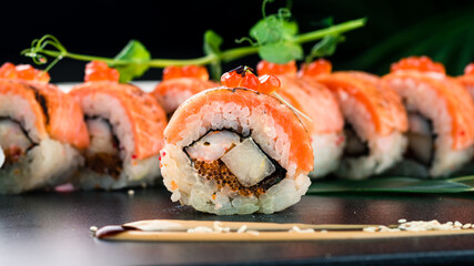 Sushi rolls with smoked salmon, shrimp, flying fish roe, rice and nori.