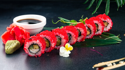 Set of California sushi rolls with shrimp, cream cheese, avocado, cucumber in red flying fish caviar with wasabi, ginger and soy sauce.