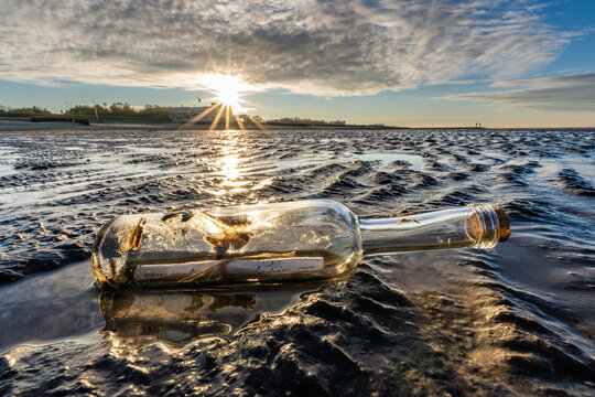 bottle post in the Wadden Sea at sunset