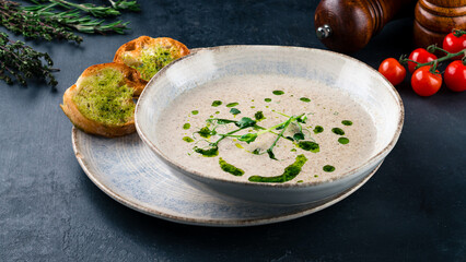 Champignon cream soup with microgreens and croutons.