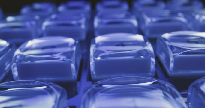 Glowing buttons on futuristic control unit in blue shimmering light to control spaceship 