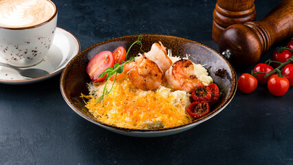 Scramble eggs with shrimps, cheese, cherry tomatoes, microgreens and cup of coffee.