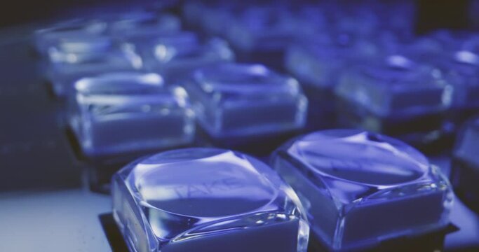 Smooth reveal macro shot of transparent buttons on studio film equipment gear in blue technical light