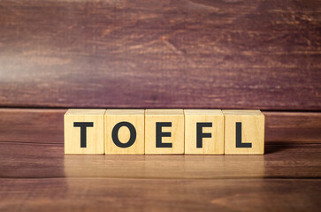 TOEFL - short for Test of English as a Foreign Language - text written on wooden block
