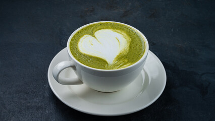 Cup of green tea matcha latte with milk.