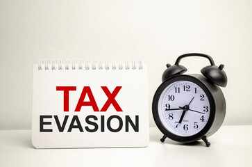 TAX EXTENSION words with clock with notebook