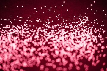 Beautiful Christmas viva magenta light background. Abstract glitter bokeh and scattered sparkles