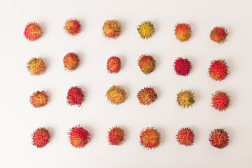 Group of red rambutan sweet delicious fruit isolated on white background, flat lay top view