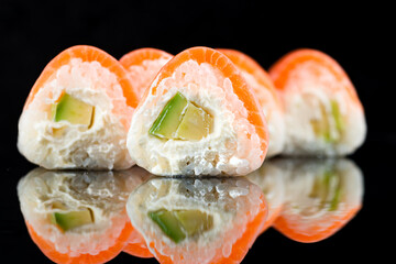 Fresh set of sushi rolls Philadelphia with salmon, cream cheese, avocado, rice and nori.