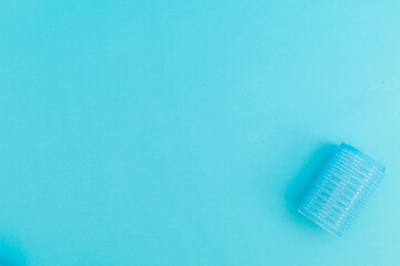 Blue hair curlers on a blue background