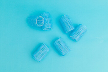Blue hair curlers on a blue background