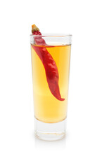 Glass of honey vodka with chili pepper isolated on white background. Spicy hard alcohol drink.   