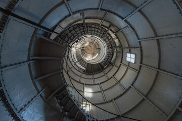 Iron spiral staircase inside the old lighthouse, bottom view