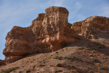 Fototapeta na wymiar Sandy canyon with red rocks. Charyn.